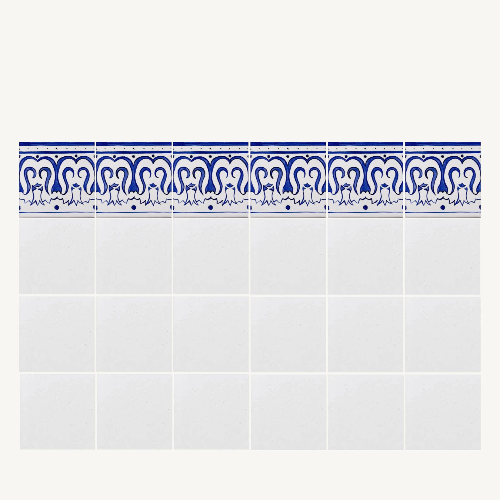 ściana białych kafli zwieńczonych linią kolorowej bordiury z wzorem