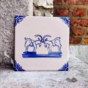 kafelek z koziołkami na tle ceglanej ściany