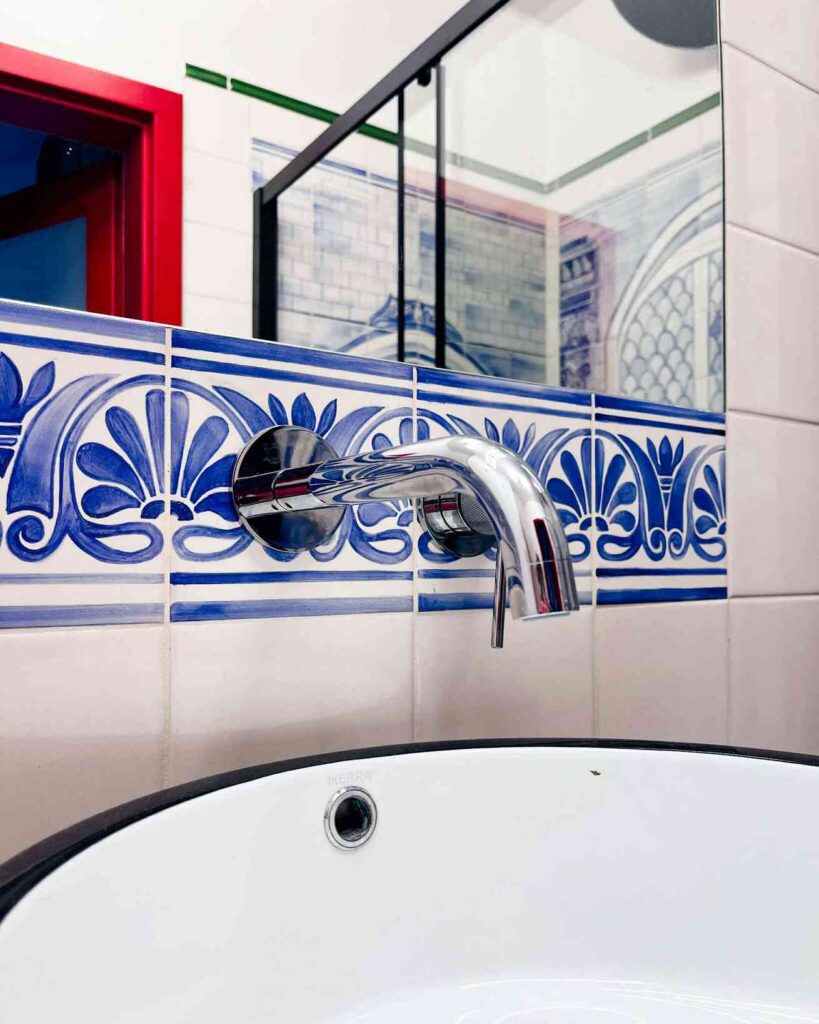 Kafelki ręcznie malowane z ornamentalnym wzorem nad umywalką