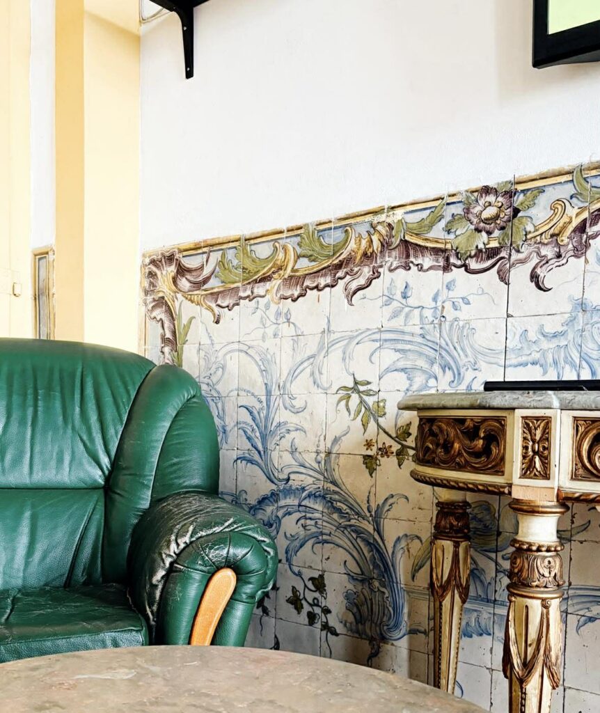 obdrapany fotel i neoklasycystyczne azulejos w lizbońskim pałacu